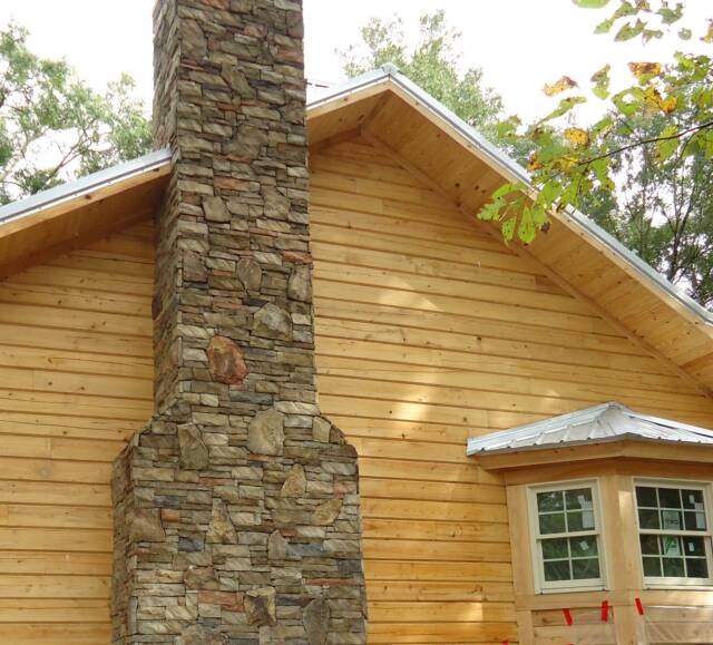 cypress log home fireplace stone